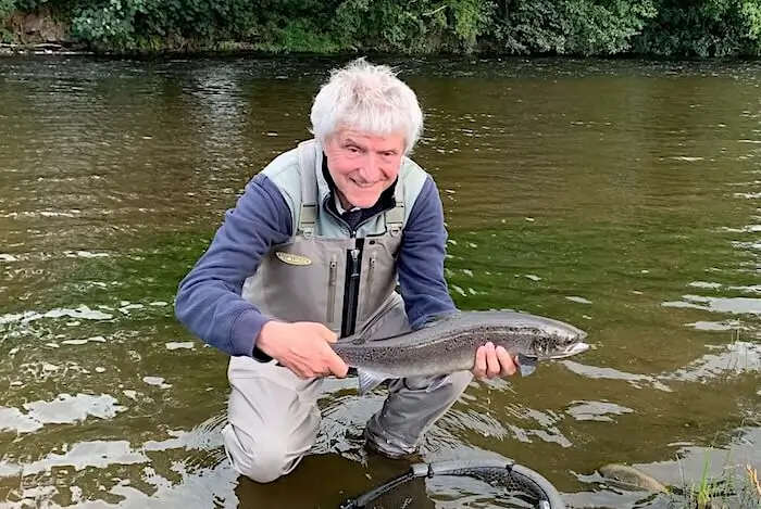 Buddy fly fishing for salmon in autumn Welsh Dee